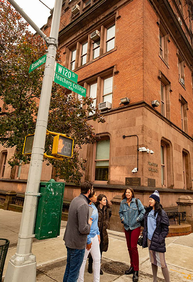 Students standing under the TC Way sign