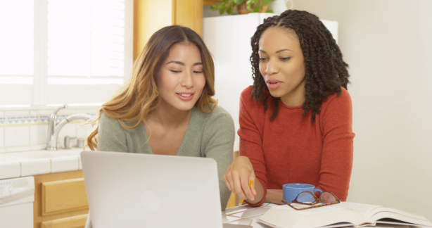 asian and black college students studying with laptop