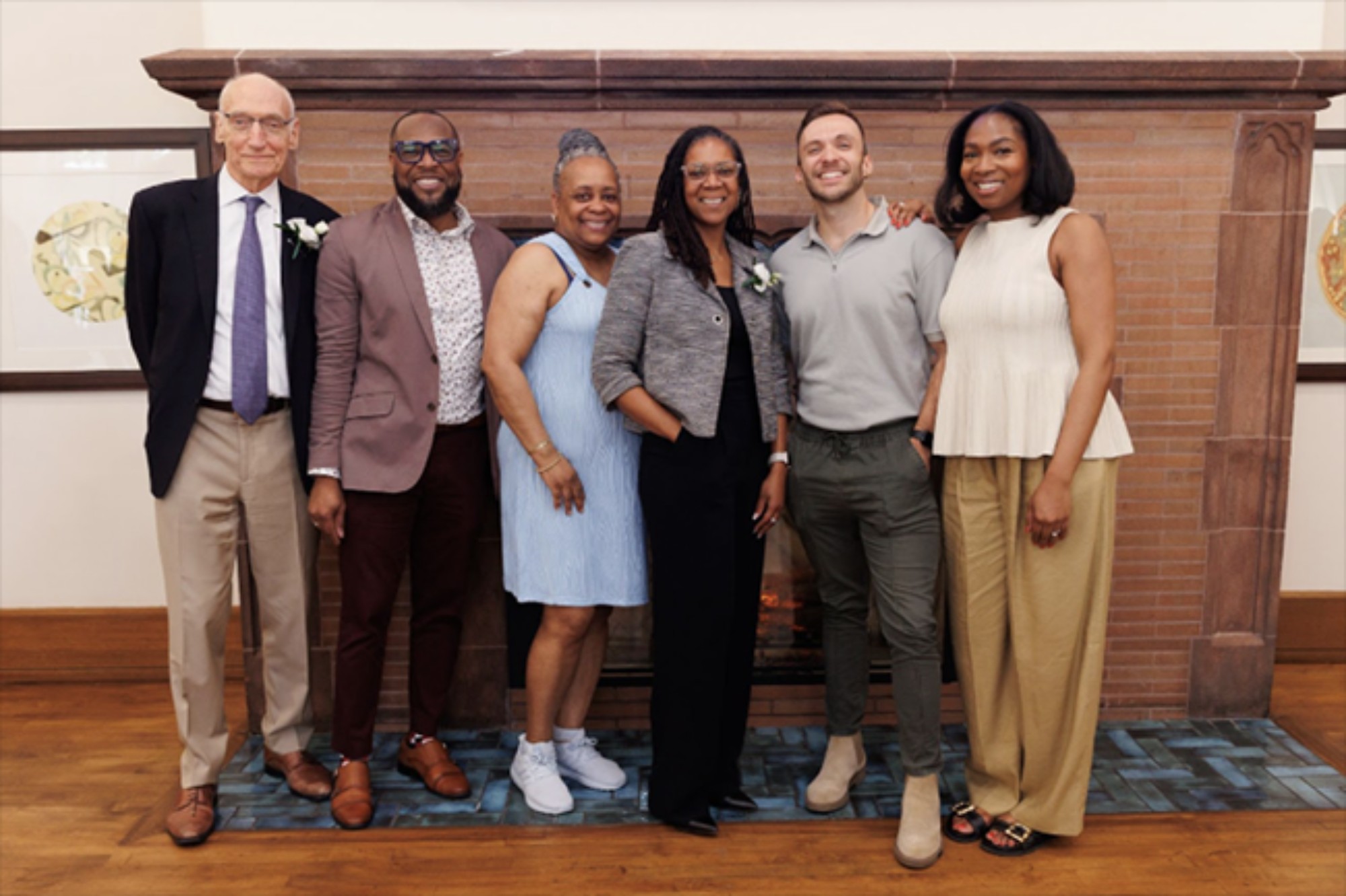 Six people standing and smiling at the Long Term Employee Recognition ceremony in Everett Lounge