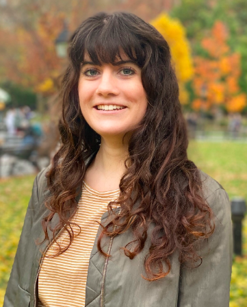 Headshot with a background of fall foliage