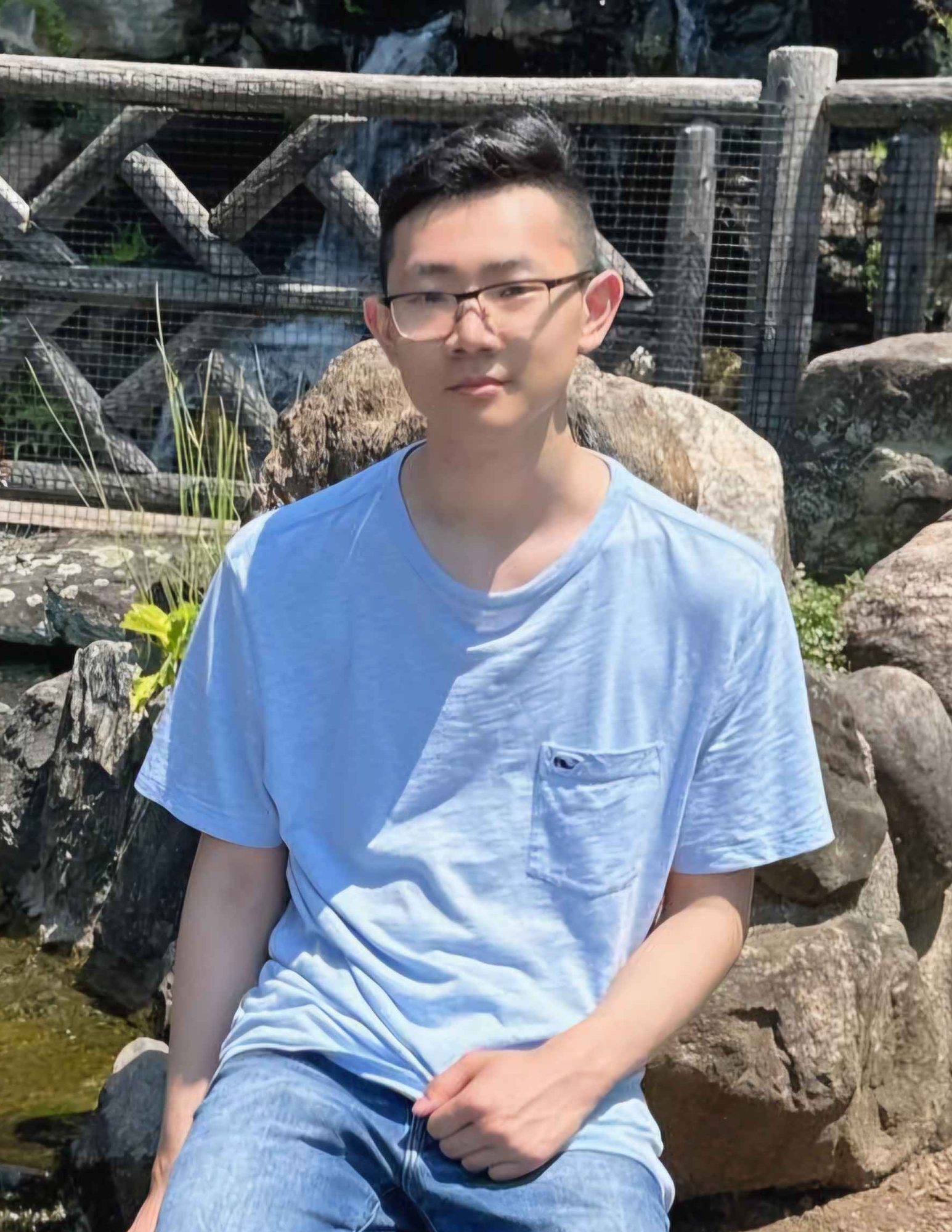 Student sitting beside a waterfall