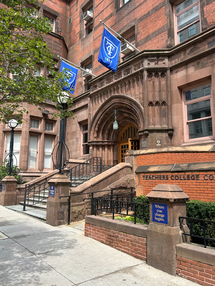 Entrance with staircase leading into brown historic Teachers College building