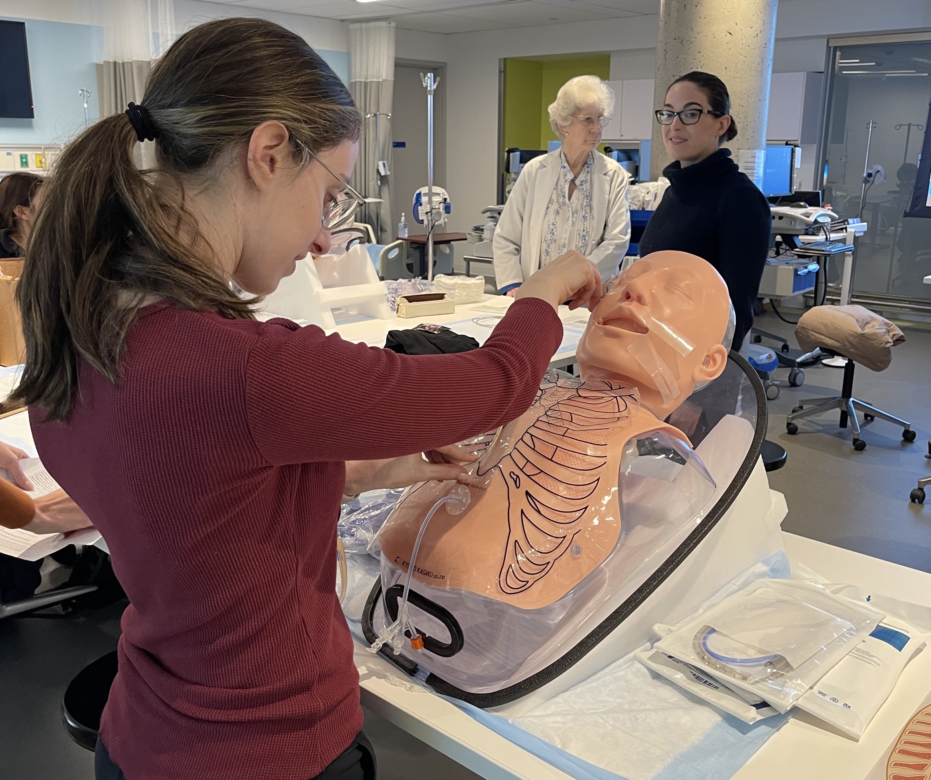 Female student practicing enteral tube placement in lab setting