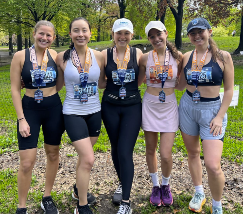 Picture of five women standing together with marathon medals around their necks.