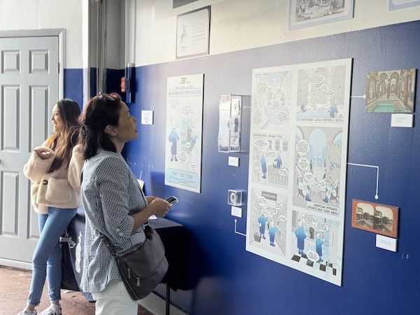 Professor Yoo Kyung Chang in front of the Brooklyn Seltzer museum’s newly implemented comic wall