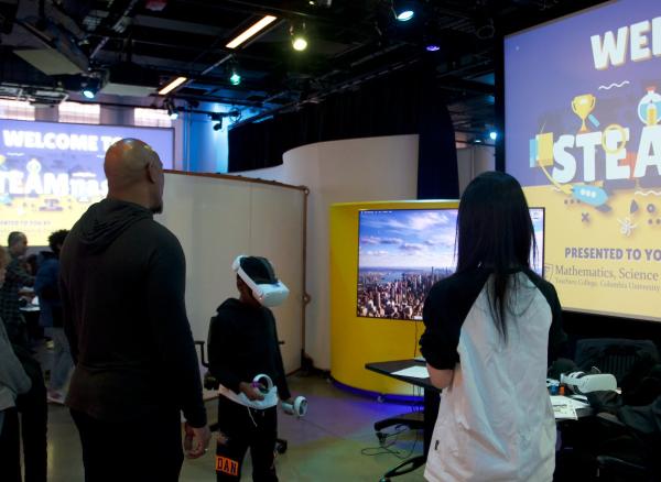 Student participant with a VR headset on playing Strivers of Onyxia