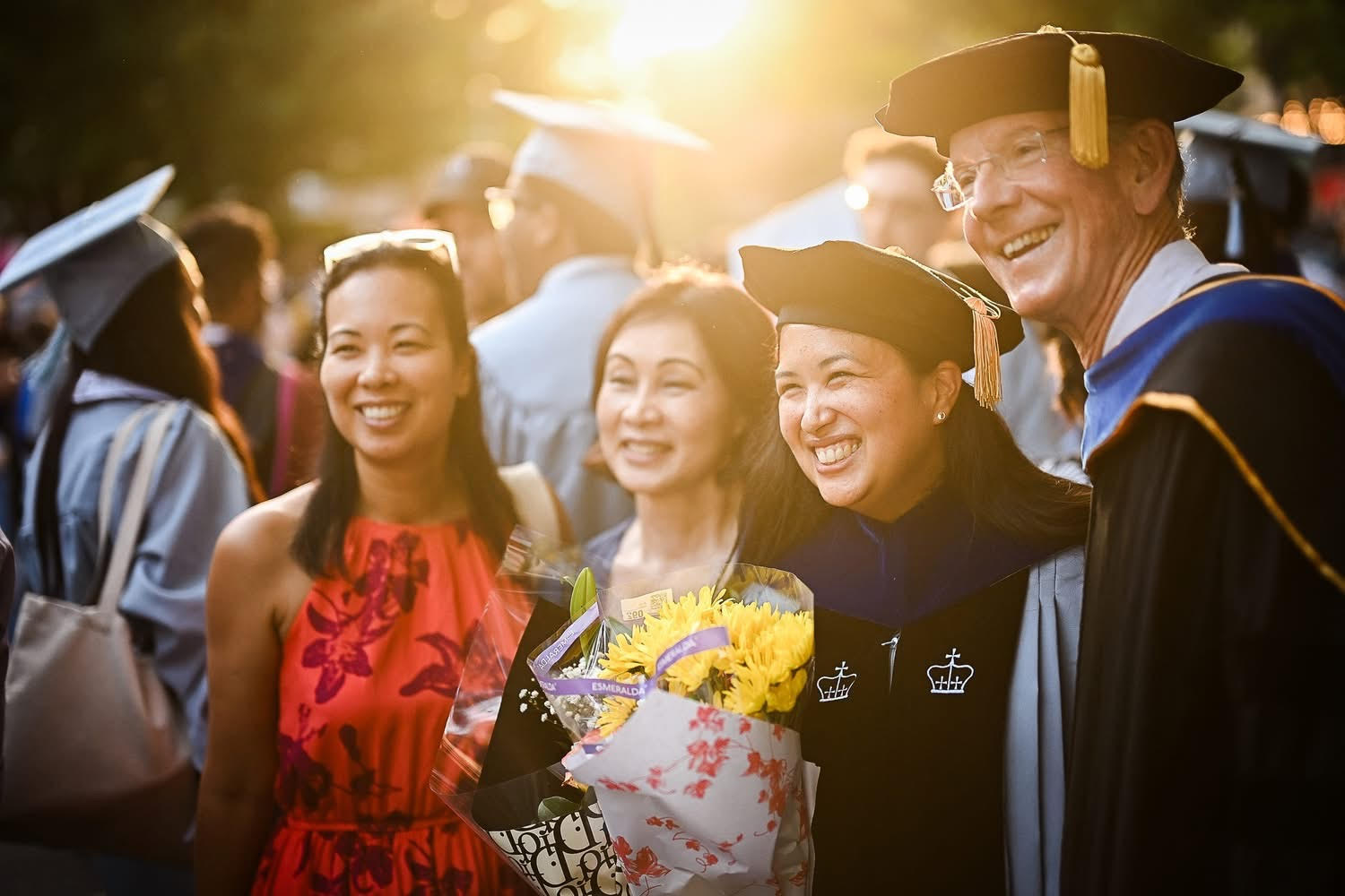 Dr. Emy Cardozza alongside her mother, sister, and Professor David Hansen.
