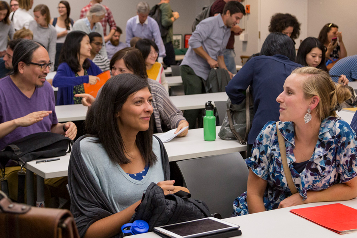 Graduate students talking actively in class.