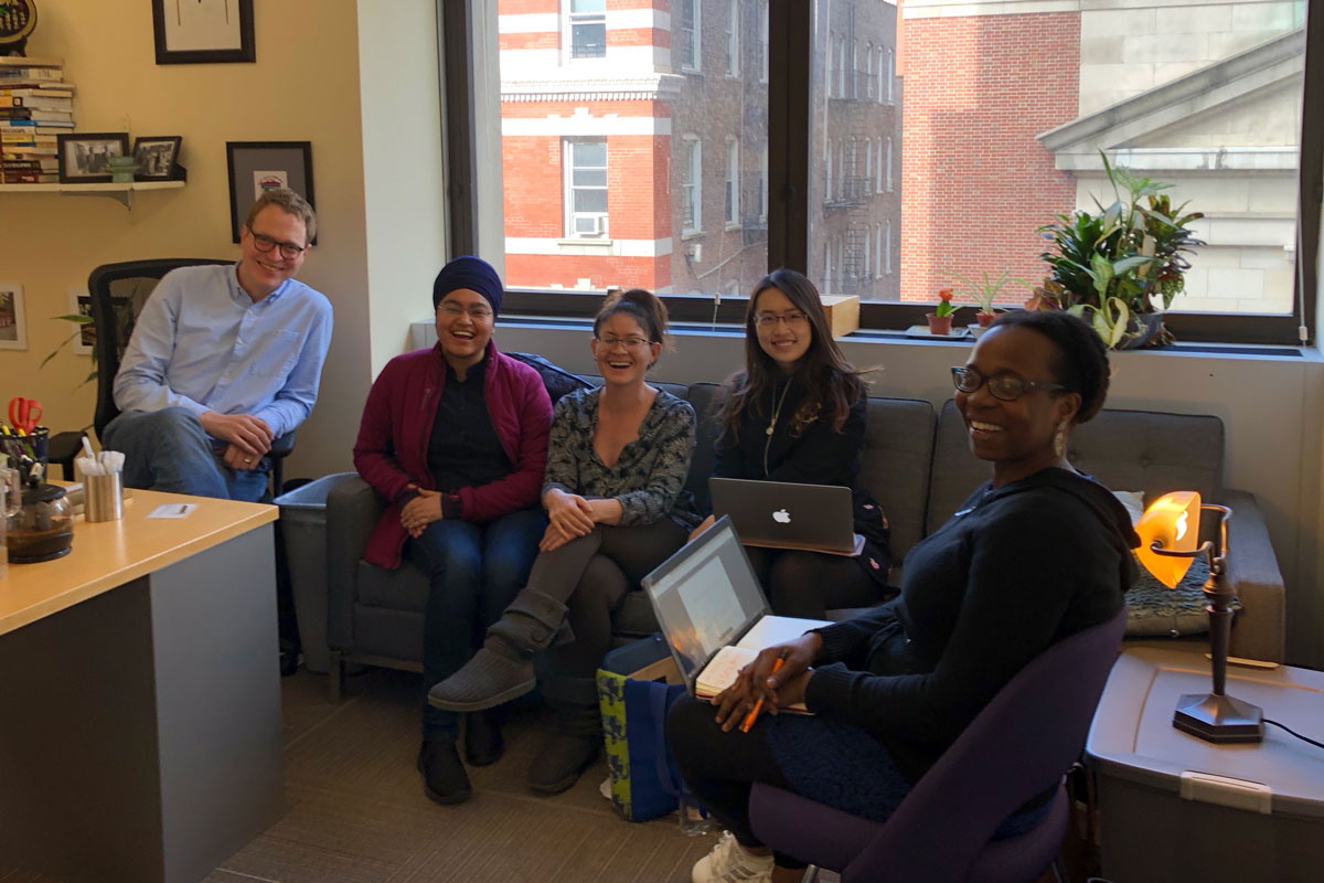 Students meet with a faculty member in Econ and Ed