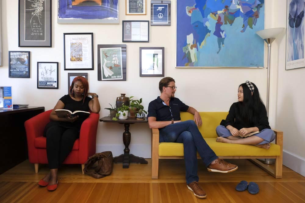 Students reading and chatting in a faculty office