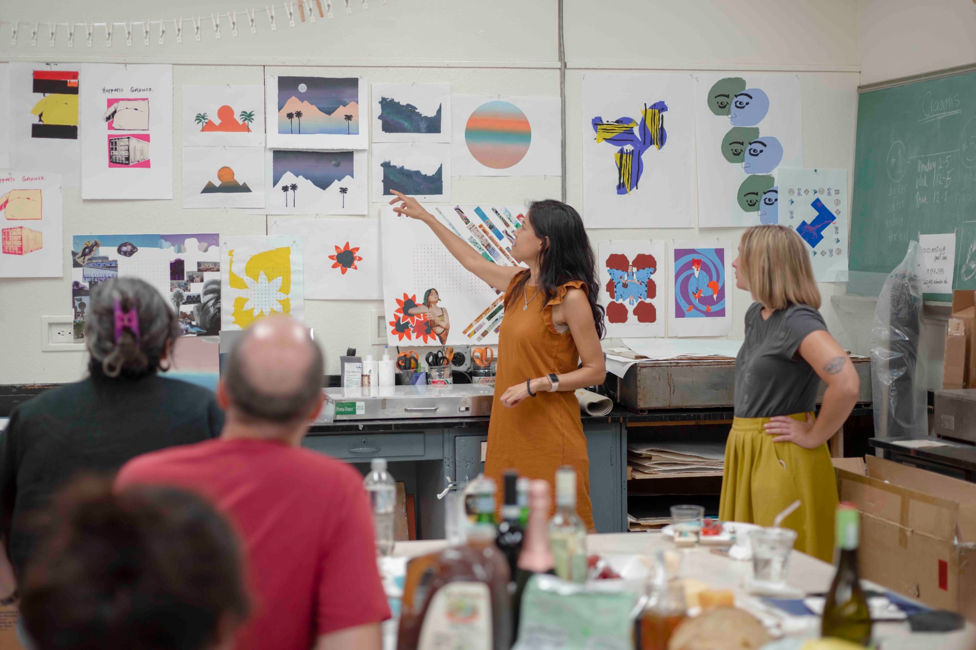 This is a picture of graduate students in the printmaking studio during a critique of their work.