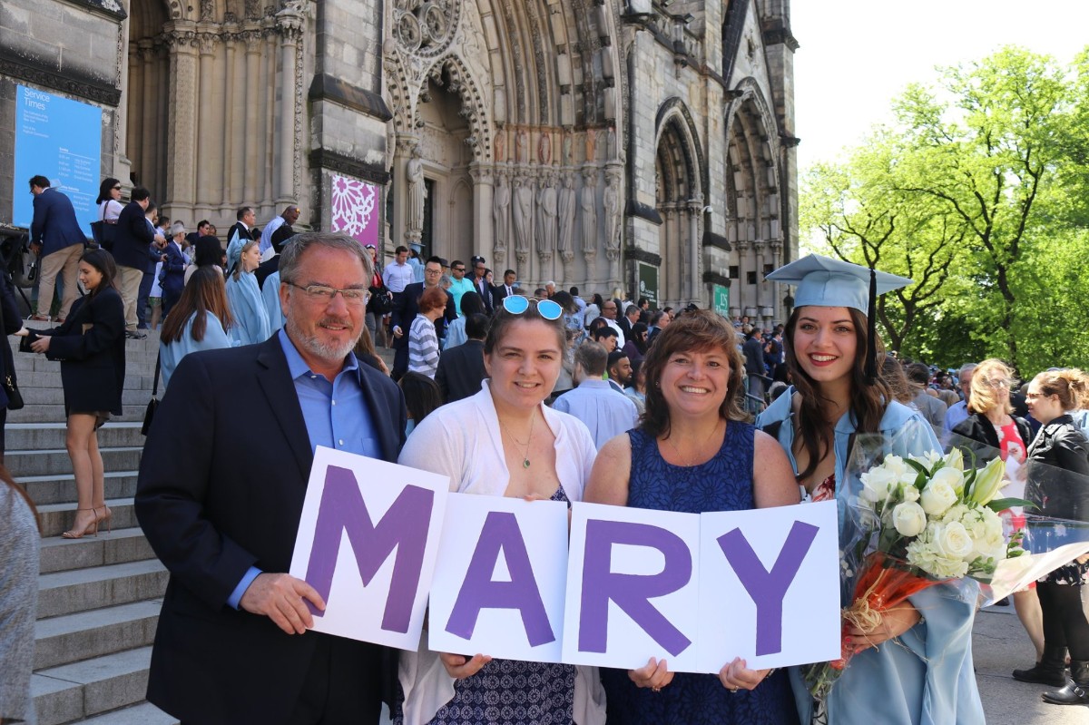 Students pose for a photo with parents after Convocation