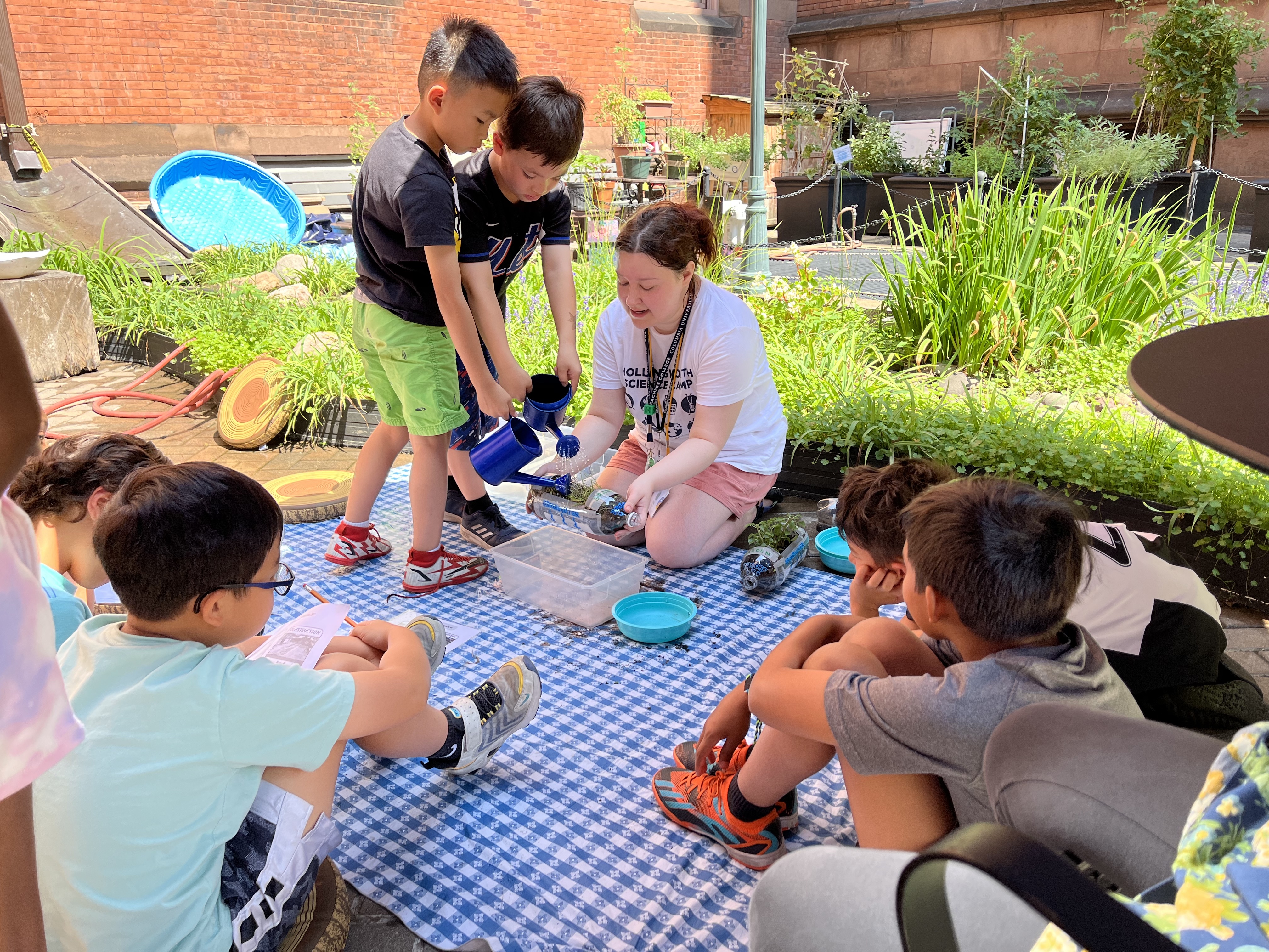 Students engage in a rainwater simulation activity.