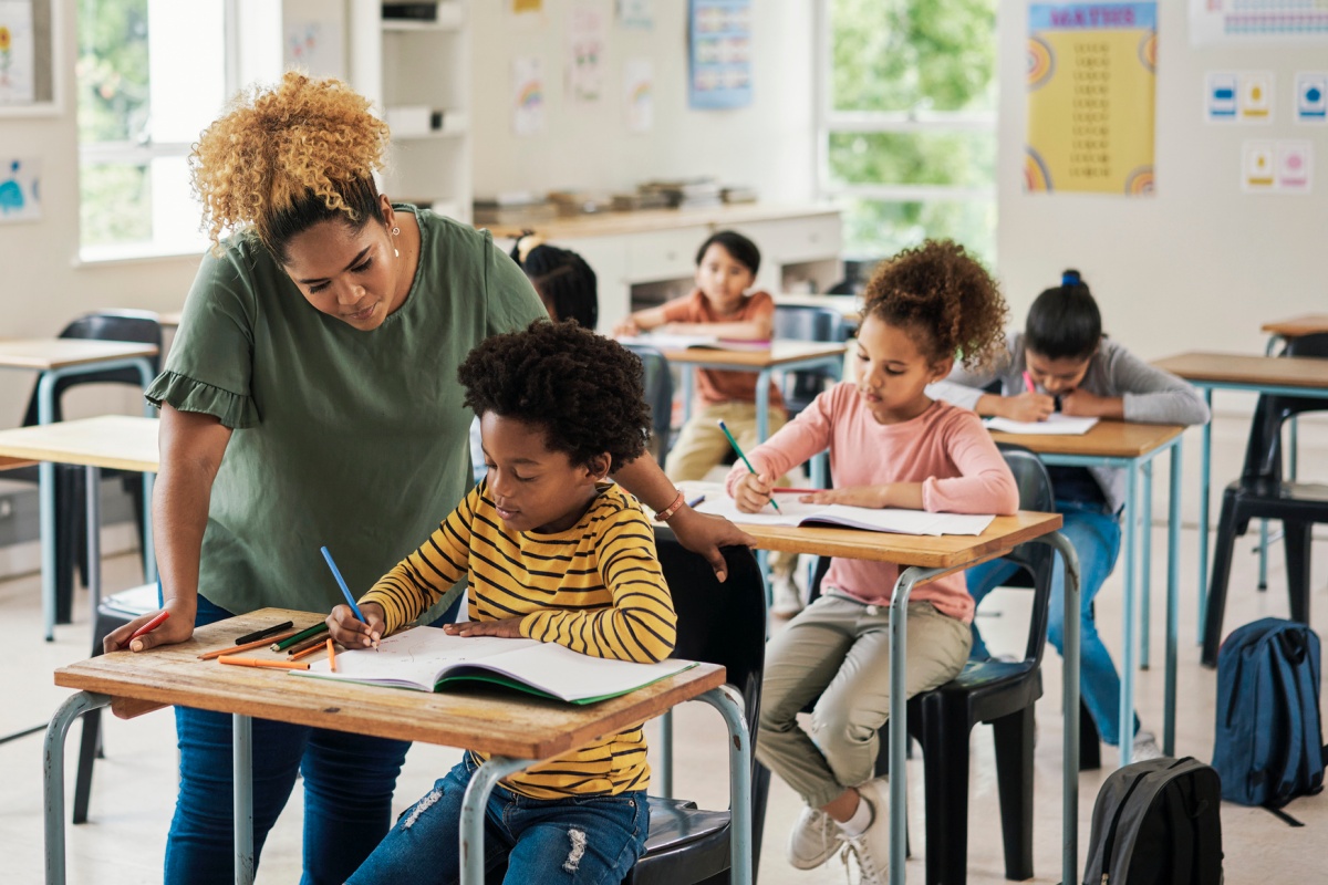 Teacher helping student.