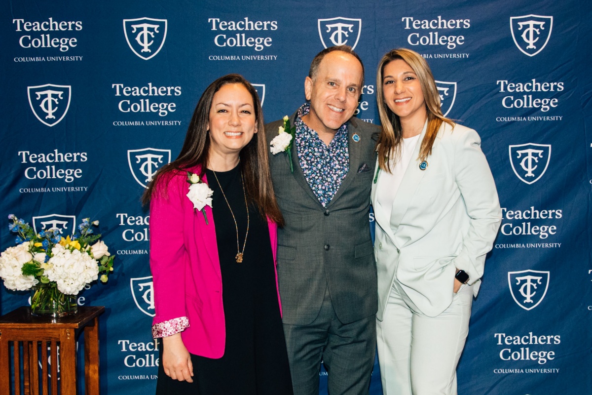 Group photo of three staff members, smiling