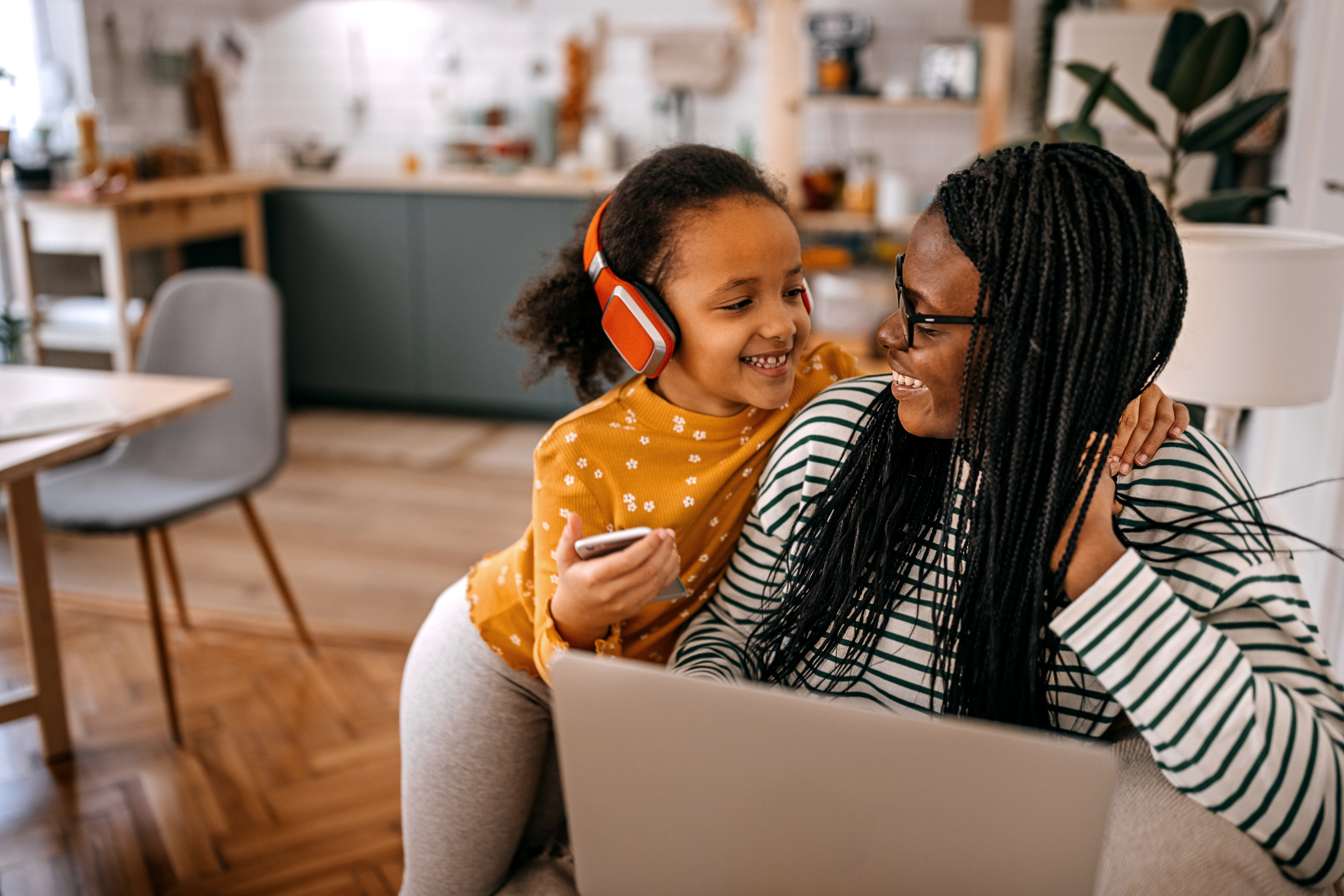 Mother and daughter listen to music together.