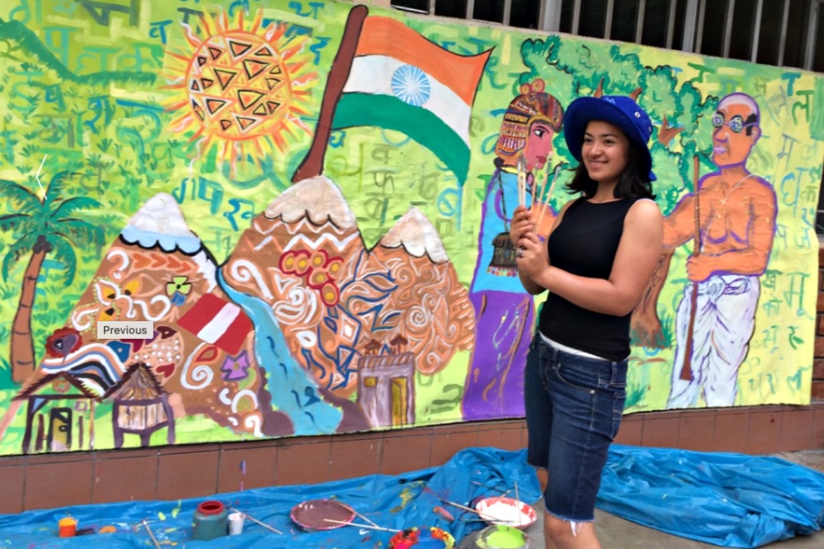 Girl in front of mural