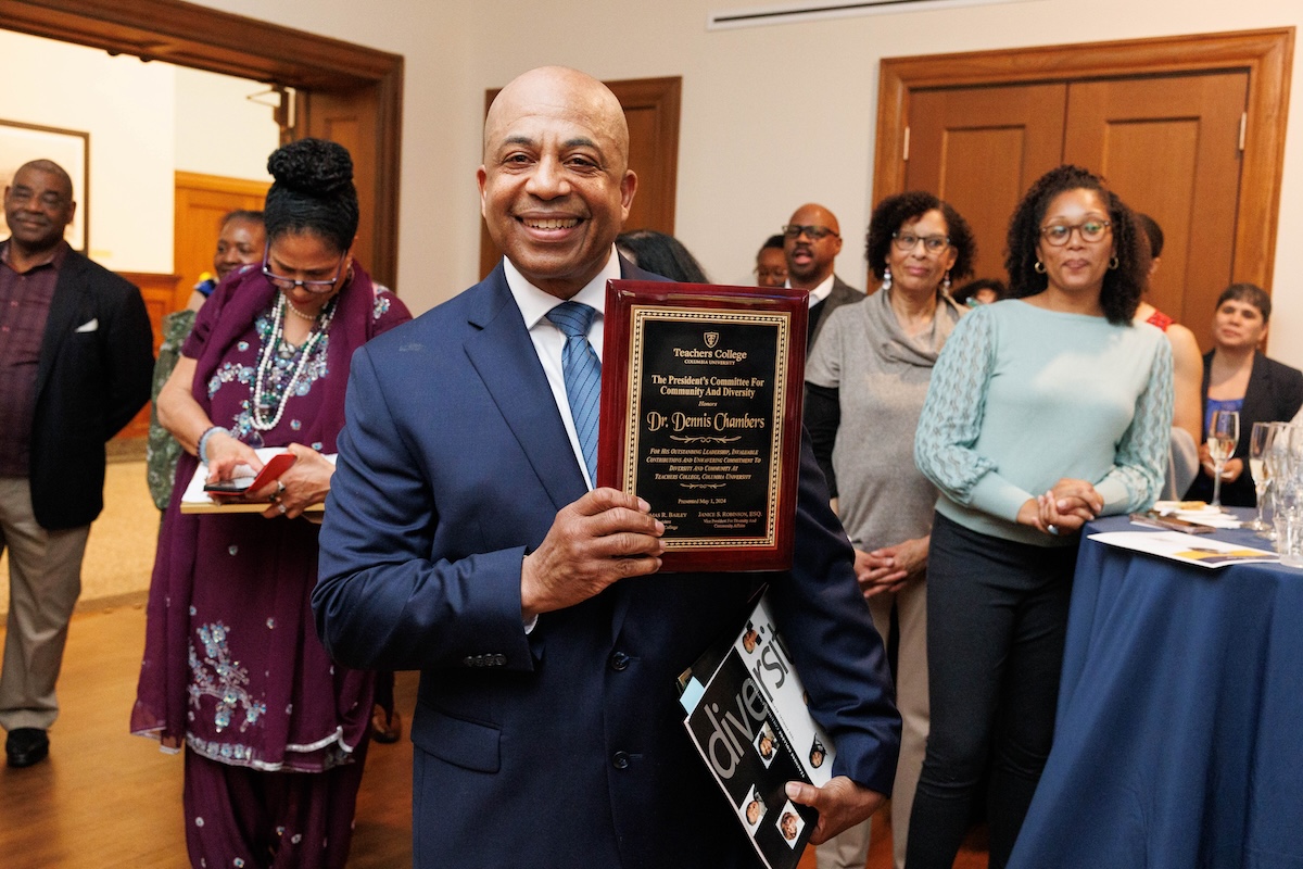 Dennis Chambers with a plaque