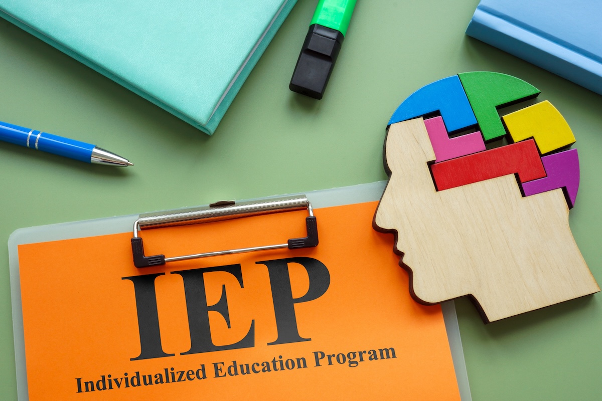 Clipboard with IEP Individualized Education Program and head model. stock photo