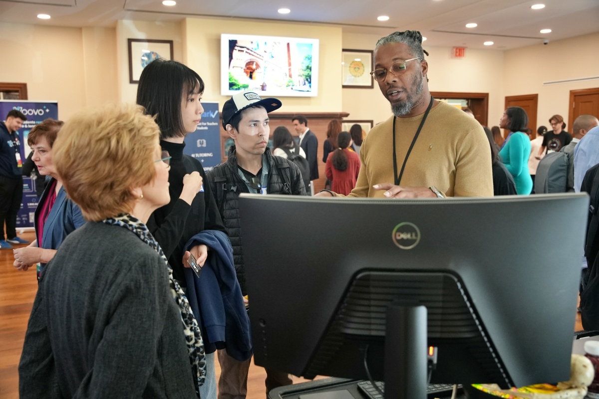 Students and Professor Ellen Meier speak with an employer during EdTech Week 2024.