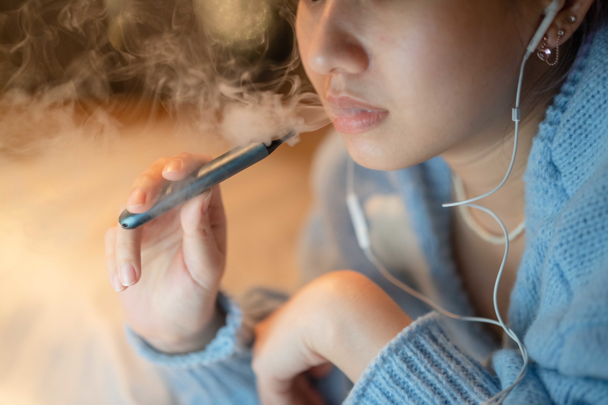 Teenager using a vape.