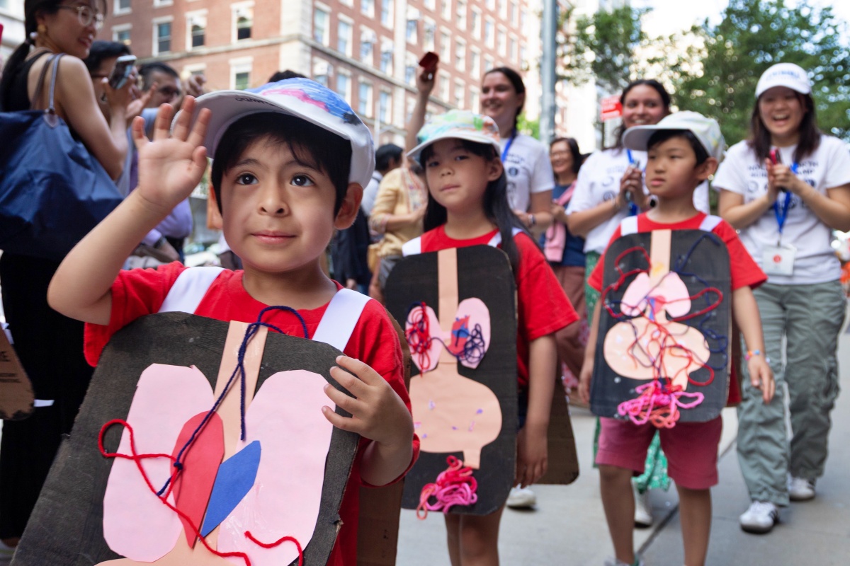 Children show their crafted diagrams of the human GI system during the Hollingworth Science Camp Parade.
