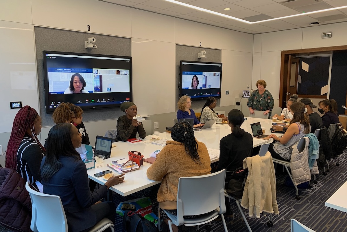 A group of educators, mostly women, sitting around a table