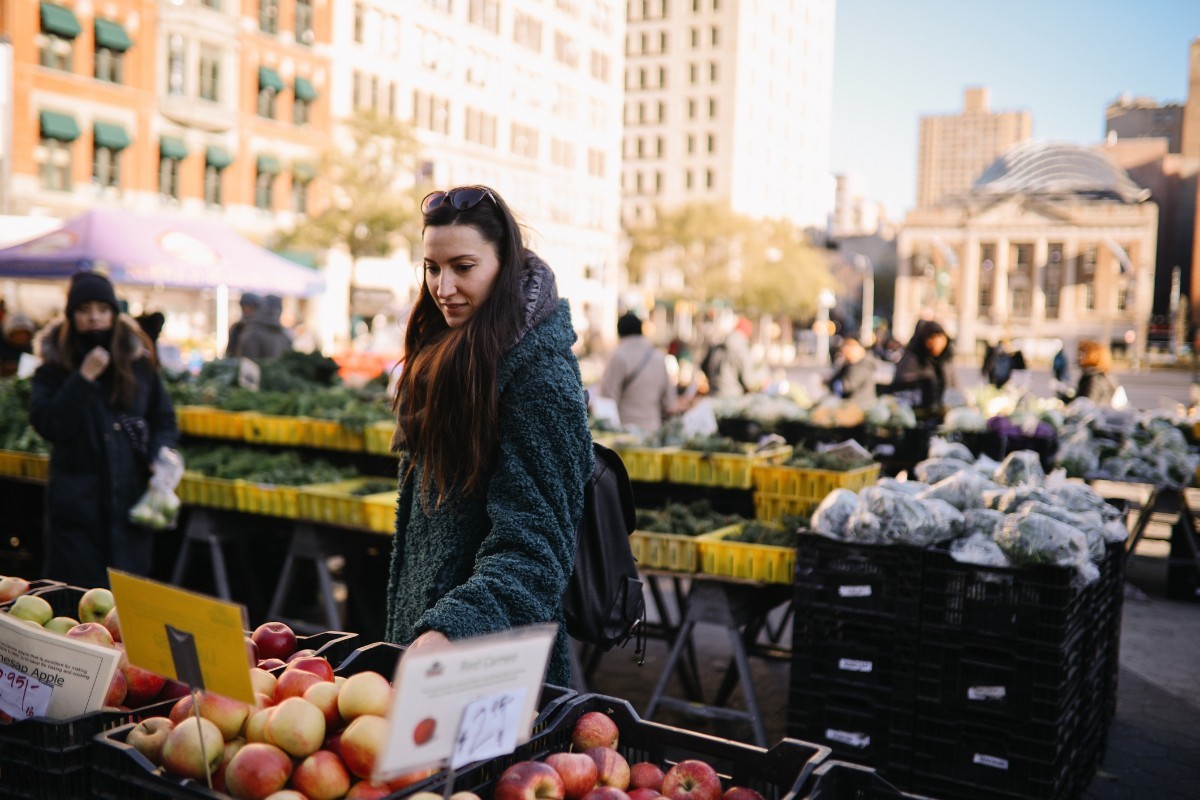 Pictured: Woman shopping at famers' market.
