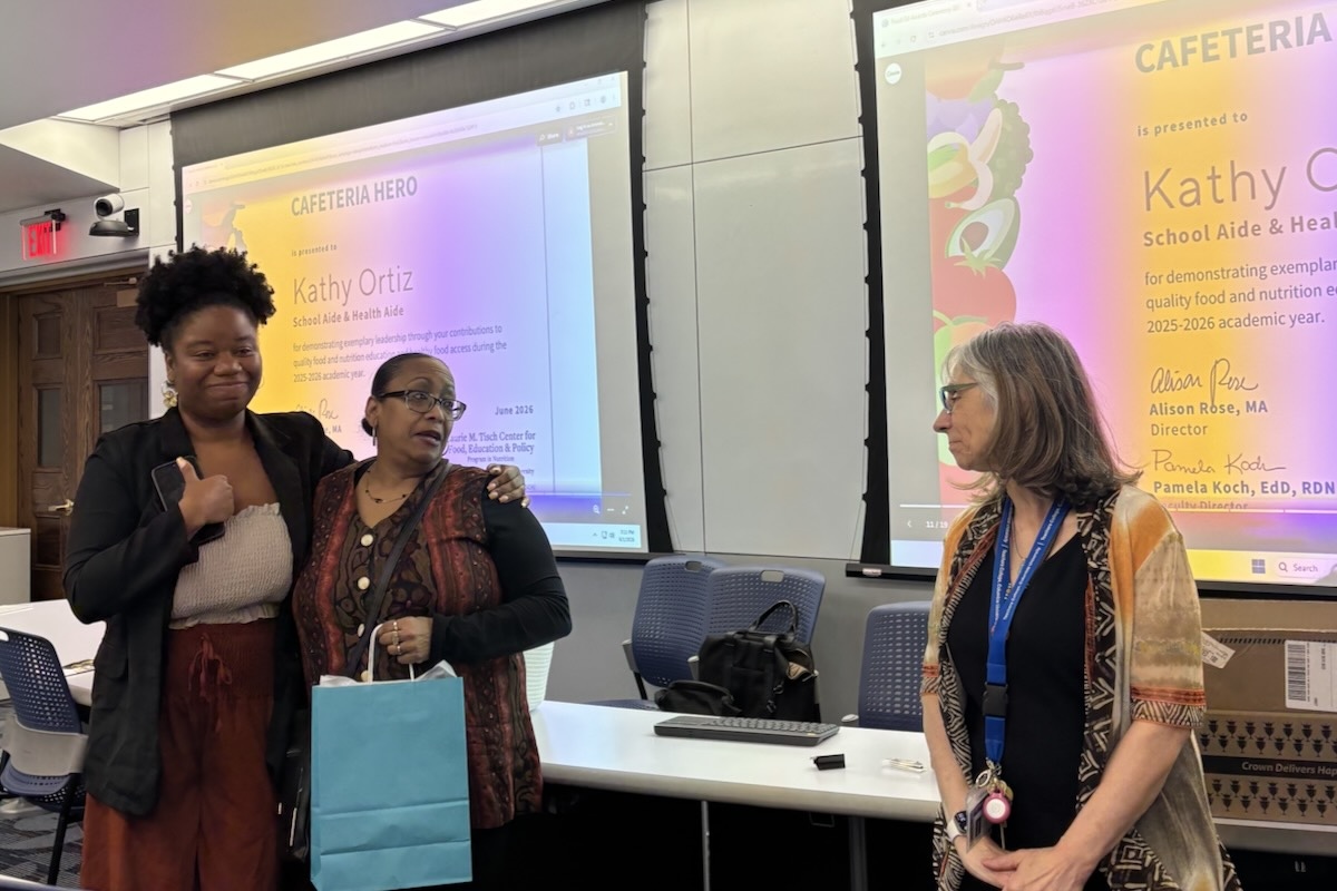 Three women having a conversation in a classroom