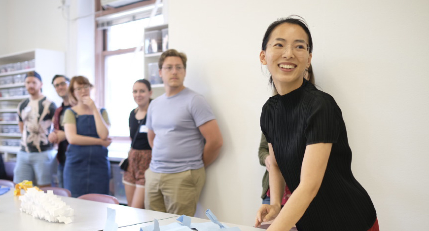 Five students standing in a classroom